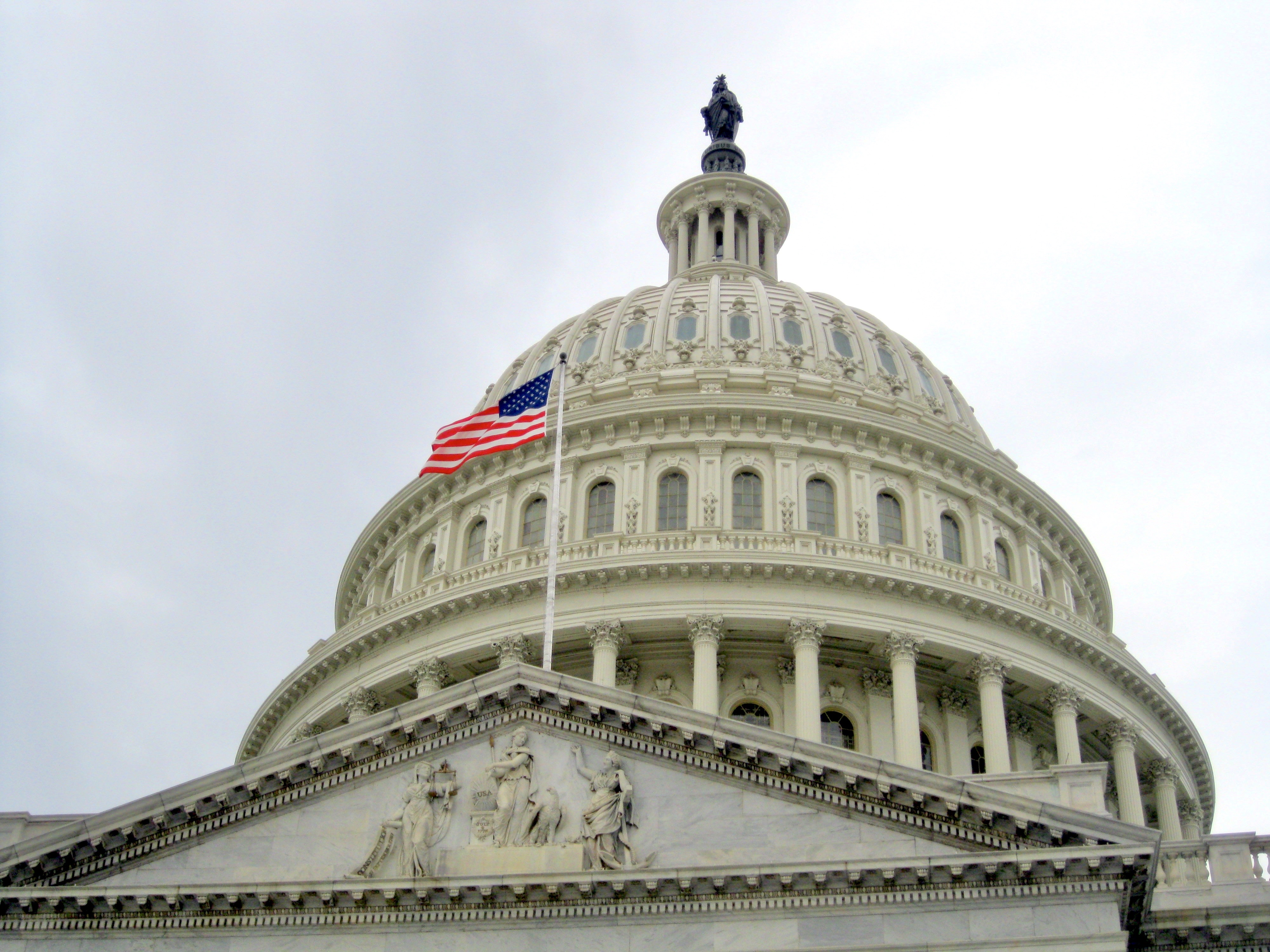 View of the Capitol Building Dome with the United States flag in Washington D.C during USA travel