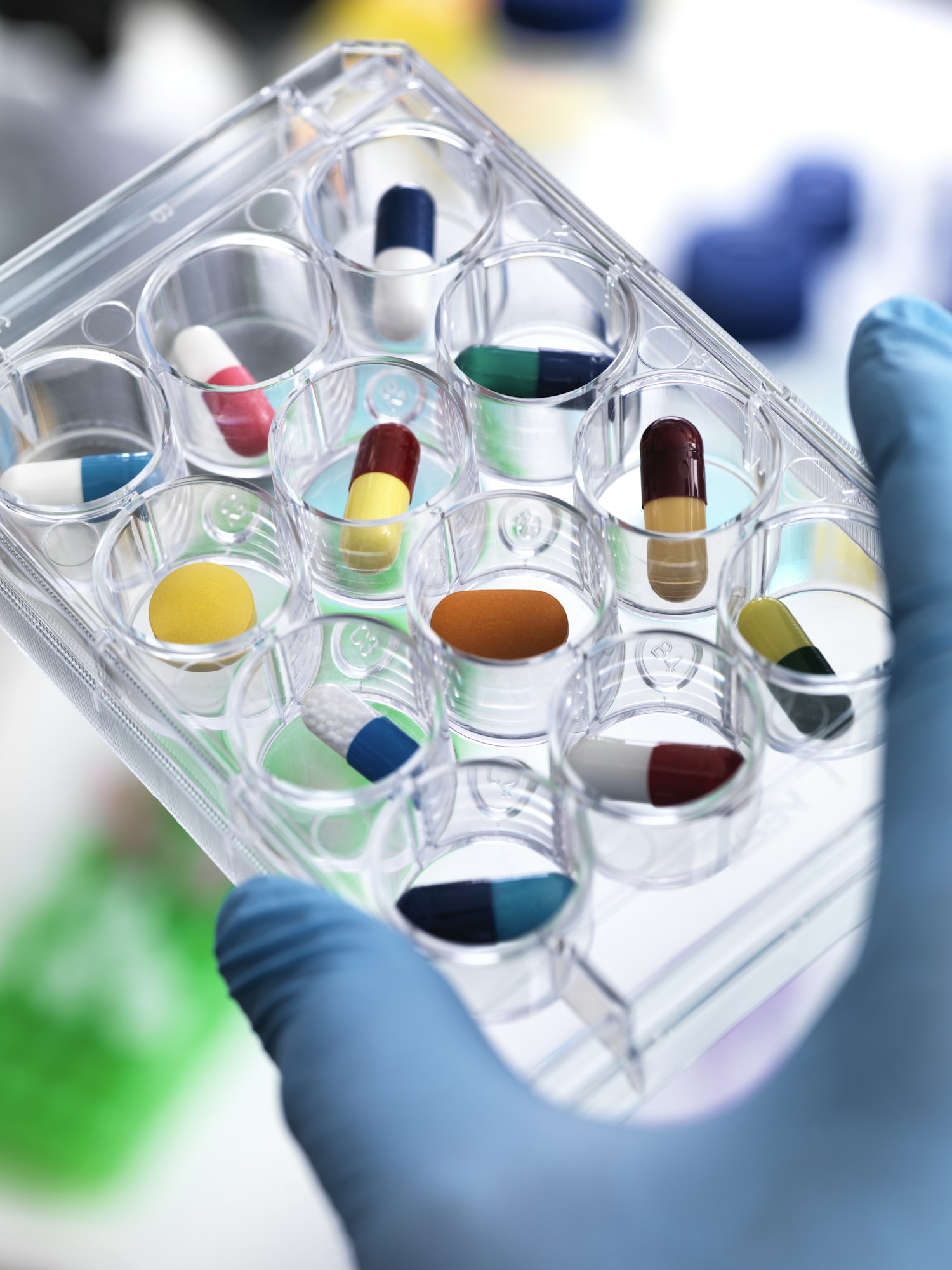 Pharmaceutical Research, Scientist holding multi well plate