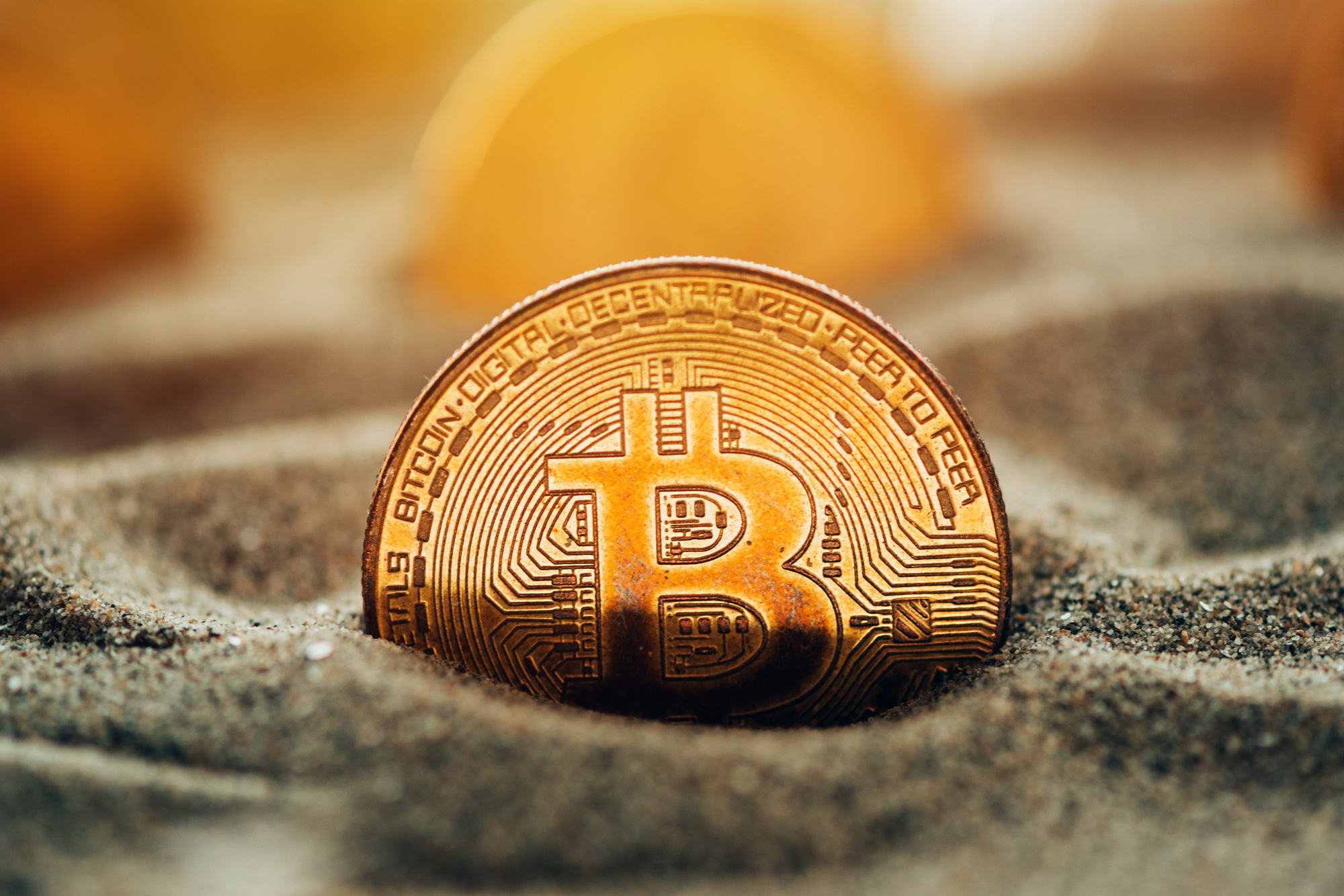Bitcoins in sand