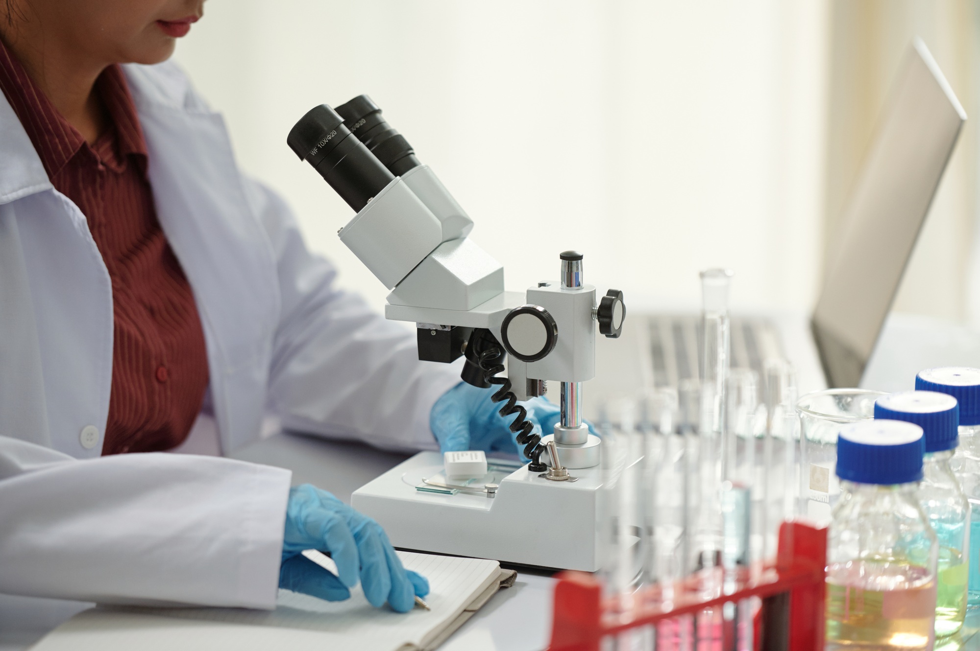 Pharmaceutical Scientist Working with Microscope